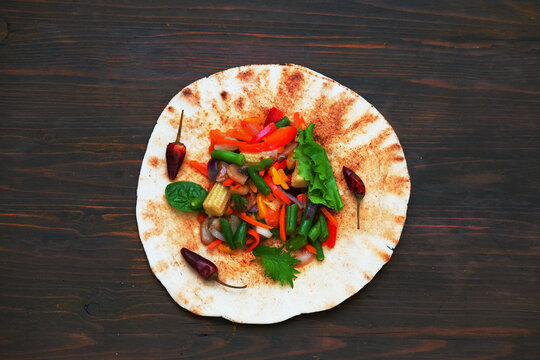Corn tortilla tacos with vegetable filling on wooden background. Traditional dish of Mexican cuisine or World Vegan Day.  - Powered by Adobe