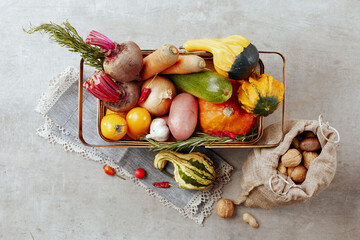 autumn flat lay on concrete background with pumpkins