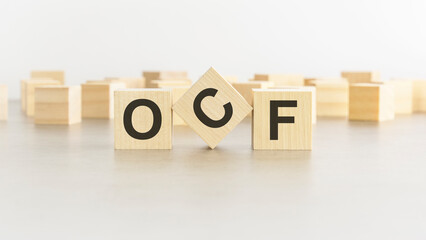 word OCF is made of wooden blocks on white background