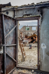 Ruined house. Ruins of a residential building. Brick walls. War in Ukraine. A house destroyed by a rocket and fire. A pile of bricks. A burnt life. Russian peace. Consequences of Russian aggression.