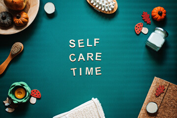 Self-care time word on green background flat lay. Self-care time text wooden letters with body face...