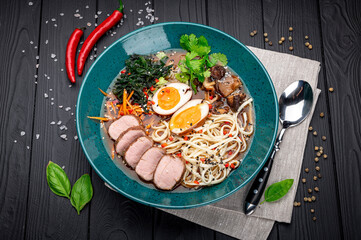 Asian ramen soup with meat, homemade noodles, mushrooms and pickled egg