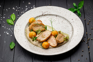 Fried bull testicles with potatoes and mushroom sauce.