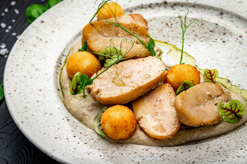 Fried bull testicles with potatoes and mushroom sauce.