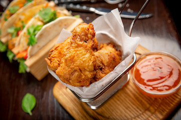 Fried chicken wings in batter with hot sauce