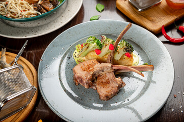 Different colorful meals on dark wooden table in the restaurant.