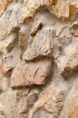 Natural stone wall with rough texture and uneven grunge surface