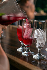 Bartender serving alcohol in a cocktail. Cocktail preparation in a night environment. It can be a hotel, a restaurant or a night club.
