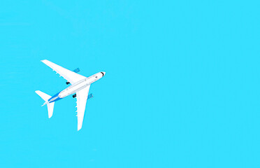 Airplane on a blue background, travel concept.