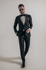 bearded young groom with hand in pocket wearing elegant tux