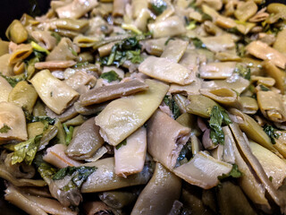 fried green beans with herbs in a pan closeup photo.