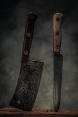 collection of cleaver and kitchen knife on top of chopping board