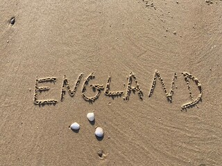 on the beach is carved with letters in the smooth sand the writing England