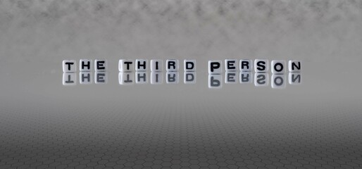 the third person word or concept represented by black and white letter cubes on a grey horizon...