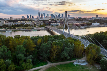 Panorama of Warsaw in Poland with Siekierkowski bridge over Vistula river during sundown.