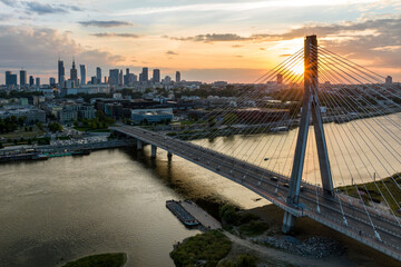 Panorama of Warsaw in Poland with Siekierkowski bridge over Vistula river during sundown. - obrazy, fototapety, plakaty