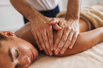 Fototapeta na wymiar Woman Enjoying Massage In Spa Centre