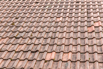 Orange roof tiles of european house, clay tiles texture