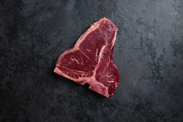 Fresh raw meat steak on dark blue background