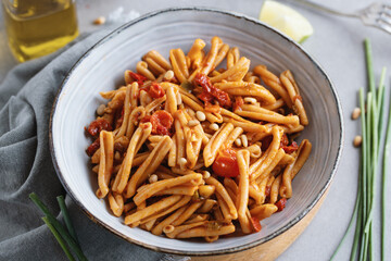 Healthy pasta with tomatoes and pine nuts