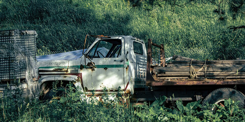Old truck abandoned in field