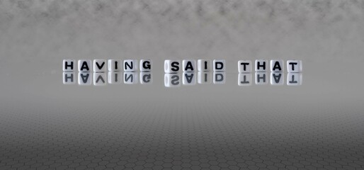 having said that word or concept represented by black and white letter cubes on a grey horizon...