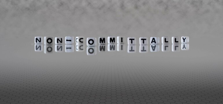 non committally word or concept represented by black and white letter cubes on a grey horizon background stretching to infinity