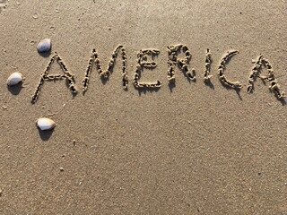 on the beach is carved with letters in the smooth sand the writing USA