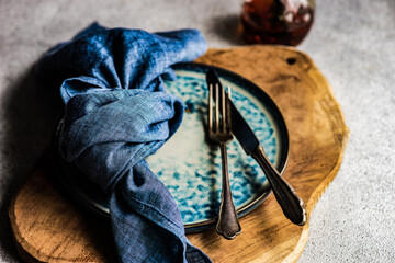 Overhead view of a rustic place setting on a wooden place mat
