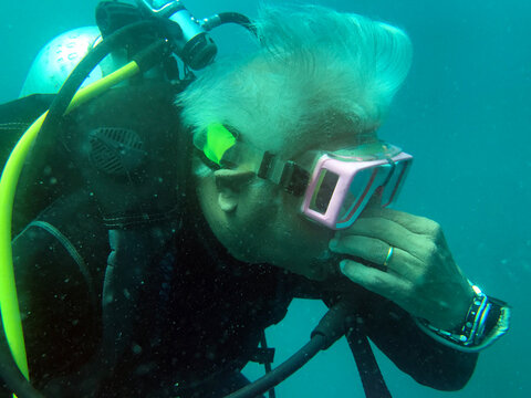 Close-Up of an active senior man scuba diving, Mu Ko Similan National Park, Similan Islands, Thailand