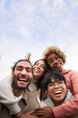 Vertical pic of Group of young people looking at the camera outdoors. Happy smiling friends...