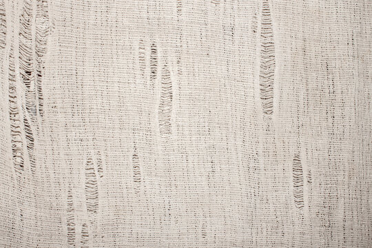 The texture of the canvas fabric.Old rag background.An old rag for washing floors.The background of an old ragged rag.