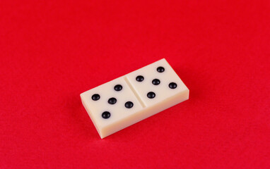 One white part of domino on red background