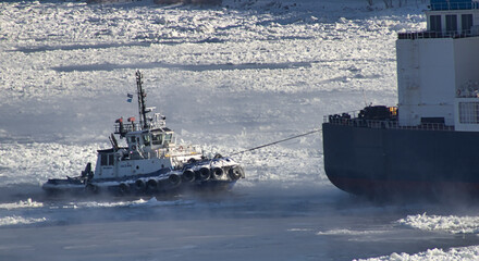 A towing boat on a frozen river near Quebec city