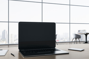 Close up of empty notebook screen on wooden office desktop with supplies on panoramic window and city view backdrop. Mock up, 3D Rendering.