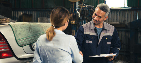 mechanic technician making handshake deal with business customer at auto car garage service,...