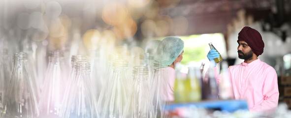 Factory worker inspecting production line of drink production in factory , Concept of food industry