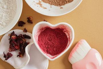 ingredients for making natural face powder. dry hibiscus petal powder, turmeric, starch