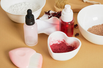 dropper bottle serum, tonic spray bottle and dried hibiscus flower petal powder, natural ingredients for DIY