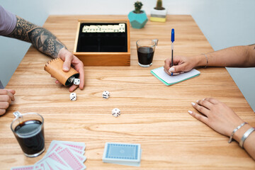 Man rolling dices while playing at home with his partner. Selective focus