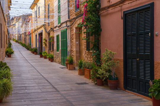 Narrow street with colorful houses in old town, Alcudia, Mallorca, Spain. Selective focus.