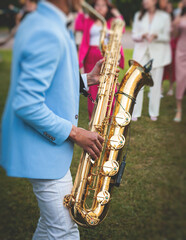 Concert view of saxophonist, a saxophone sax player with vocalist and musical band during jazz...