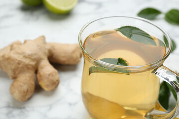 Diet herbal tea with green leaves on table, closeup