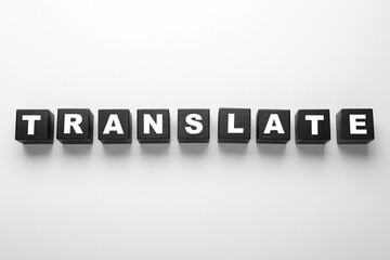 Black cubes with word Translate on white background, top view