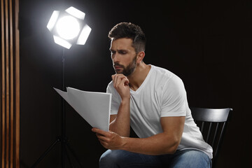 Professional actor reading his script during rehearsal in theatre - obrazy, fototapety, plakaty
