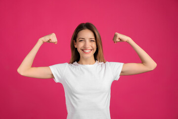 Fototapeta na wymiar Strong woman as symbol of girl power on pink background. 8 March concept