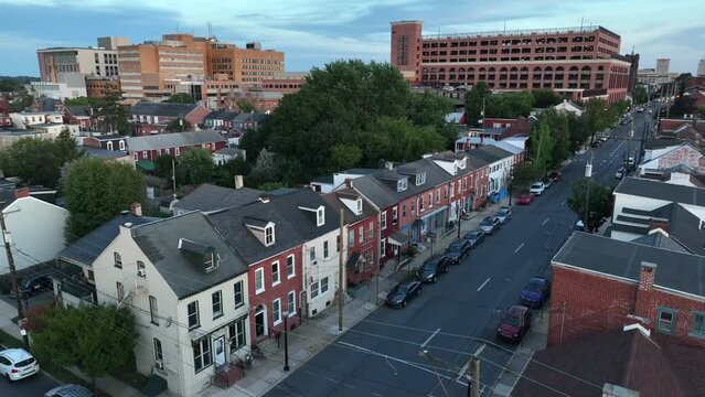 Aerial of houses along city street in east coast USA. American residential housing district establishing shot.