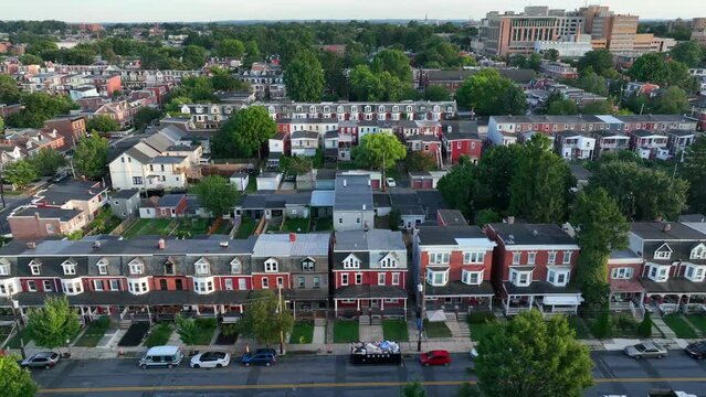 Colorful homes in downtown city in USA. American lifestyle housing view. Aerial truck shot in summer sunset.