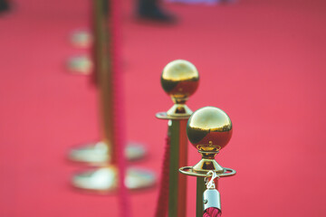 Red carpet with ropes and golden barriers on a luxury party entrance, cinema premiere film festival...