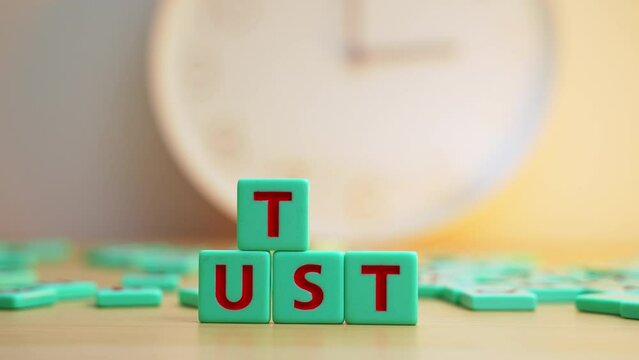 The word TRUST made with colorful letters. . High quality 4k footage
